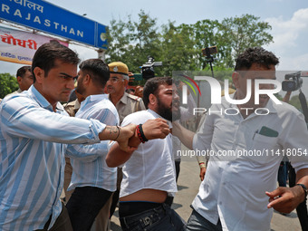 Police personnel are arresting the agitators during a protest by various student organizations demanding the conduct of Rajasthan University...