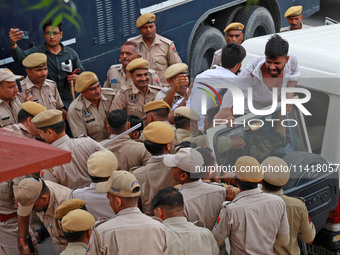 Police personnel are arresting the agitators during a protest by various student organizations demanding the conduct of Rajasthan University...