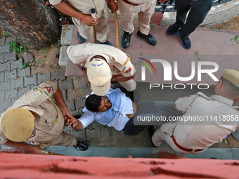 Police personnel are arresting the agitators during a protest by various student organizations demanding the conduct of Rajasthan University...