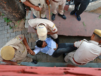 Police personnel are arresting the agitators during a protest by various student organizations demanding the conduct of Rajasthan University...