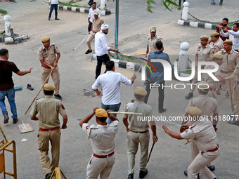 Police personnel are lathicharging the agitators during a protest by various student organizations demanding the conduct of Rajasthan Univer...