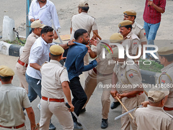 Police personnel are lathicharging the agitators during a protest by various student organizations demanding the conduct of Rajasthan Univer...