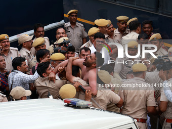 Police personnel are arresting the agitators during a protest by various student organizations demanding the conduct of Rajasthan University...