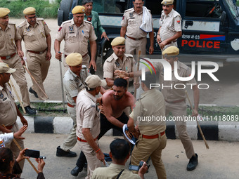 Police personnel are lathicharging the agitators during a protest by various student organizations demanding the conduct of Rajasthan Univer...