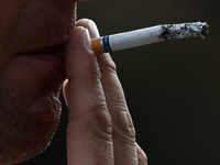 A person smokes a cigarette in Krakow, Poland on July 18, 2024. (