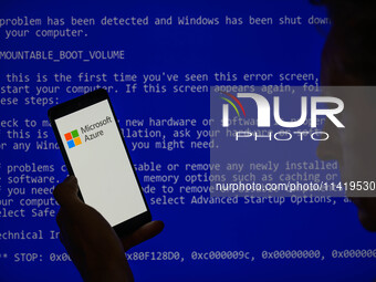 The Microsoft Azure is being displayed on a smartphone with a Windows blue screen visible in the background in this photo illustration in Br...