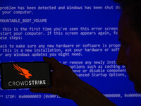 The CrowdStrike logo is being displayed on a smartphone with a Windows blue screen visible in the background in this photo illustration in B...