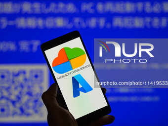 The Microsoft Azure is being displayed on a smartphone with a Windows blue screen visible in the background in this photo illustration in Br...