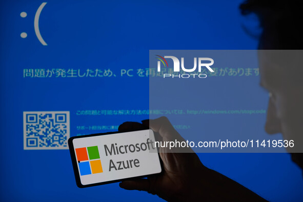 The Microsoft Azure is being displayed on a smartphone with a Windows blue screen visible in the background in this photo illustration in Br...