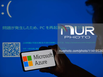 The Microsoft Azure is being displayed on a smartphone with a Windows blue screen visible in the background in this photo illustration in Br...