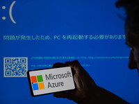 The Microsoft Azure is being displayed on a smartphone with a Windows blue screen visible in the background in this photo illustration in Br...