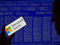 The Microsoft Azure is being displayed on a smartphone with a Windows blue screen visible in the background in this photo illustration in Br...