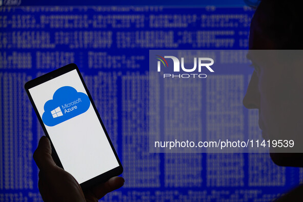 The Microsoft Azure is being displayed on a smartphone with a Windows blue screen visible in the background in this photo illustration in Br...