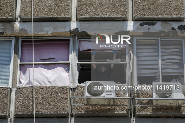 A view of a damaged building in the area of an explosion as Israeli policemen are searching the scene in Tel Aviv, Israel, on July 19, 2024....