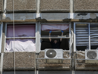 A view of a damaged building in the area of an explosion as Israeli policemen are searching the scene in Tel Aviv, Israel, on July 19, 2024....