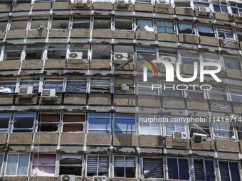 A view of a damaged building in the area of an explosion as Israeli policemen are searching the scene in Tel Aviv, Israel, on July 19, 2024....