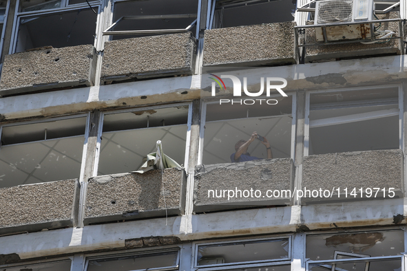 A view of a damaged building in the area of an explosion as Israeli policemen are searching the scene in Tel Aviv, Israel, on July 19, 2024....