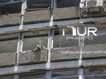 A view of a damaged building in the area of an explosion as Israeli policemen are searching the scene in Tel Aviv, Israel, on July 19, 2024....