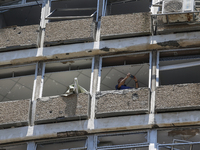 A view of a damaged building in the area of an explosion as Israeli policemen are searching the scene in Tel Aviv, Israel, on July 19, 2024....