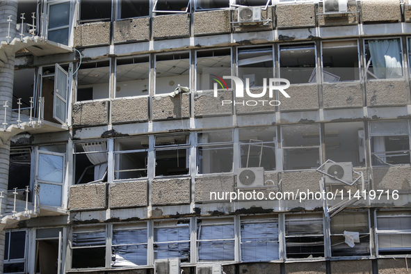 A view of a damaged building in the area of an explosion as Israeli policemen are searching the scene in Tel Aviv, Israel, on July 19, 2024....