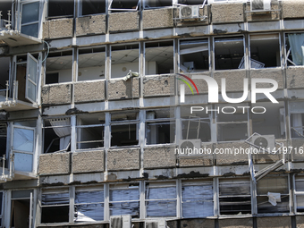 A view of a damaged building in the area of an explosion as Israeli policemen are searching the scene in Tel Aviv, Israel, on July 19, 2024....