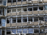 A view of a damaged building in the area of an explosion as Israeli policemen are searching the scene in Tel Aviv, Israel, on July 19, 2024....