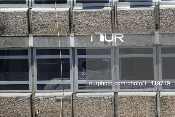 A view of a damaged building in the area of an explosion as Israeli policemen are searching the scene in Tel Aviv, Israel, on July 19, 2024....