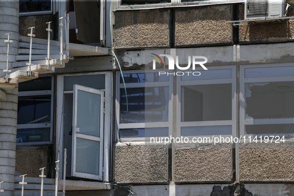 A view of a damaged building in the area of an explosion as Israeli policemen are searching the scene in Tel Aviv, Israel, on July 19, 2024....