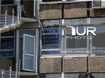 A view of a damaged building in the area of an explosion as Israeli policemen are searching the scene in Tel Aviv, Israel, on July 19, 2024....