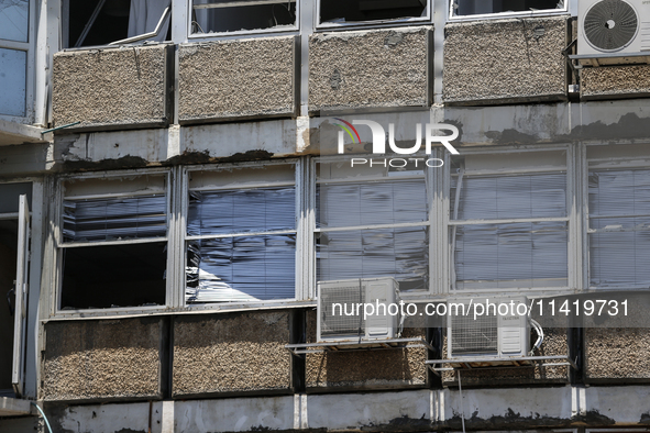 A view of a damaged building in the area of an explosion as Israeli policemen are searching the scene in Tel Aviv, Israel, on July 19, 2024....