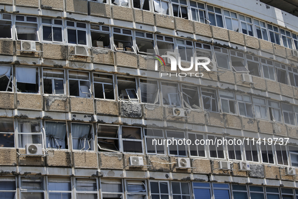 A view of a damaged building in the area of an explosion as Israeli policemen are searching the scene in Tel Aviv, Israel, on July 19, 2024....