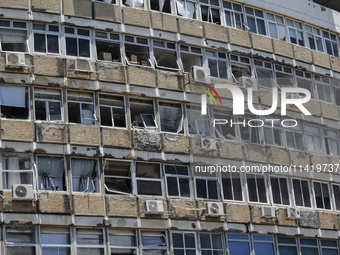 A view of a damaged building in the area of an explosion as Israeli policemen are searching the scene in Tel Aviv, Israel, on July 19, 2024....