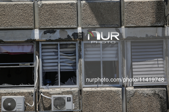 A view of a damaged building in the area of an explosion as Israeli policemen are searching the scene in Tel Aviv, Israel, on July 19, 2024....