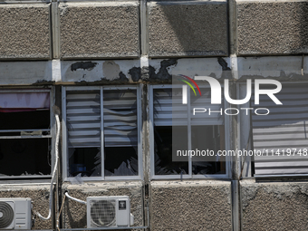 A view of a damaged building in the area of an explosion as Israeli policemen are searching the scene in Tel Aviv, Israel, on July 19, 2024....