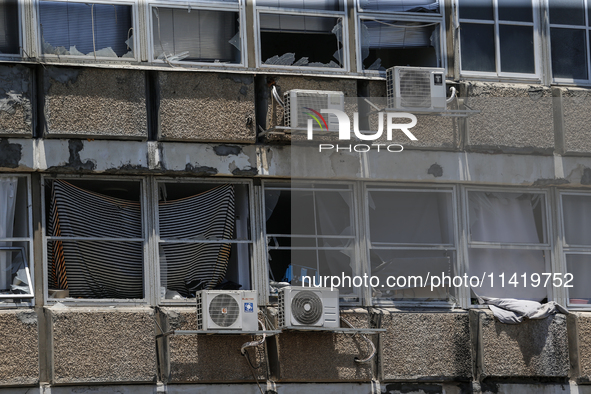 A view of a damaged building in the area of an explosion as Israeli policemen are searching the scene in Tel Aviv, Israel, on July 19, 2024....