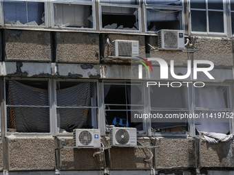 A view of a damaged building in the area of an explosion as Israeli policemen are searching the scene in Tel Aviv, Israel, on July 19, 2024....