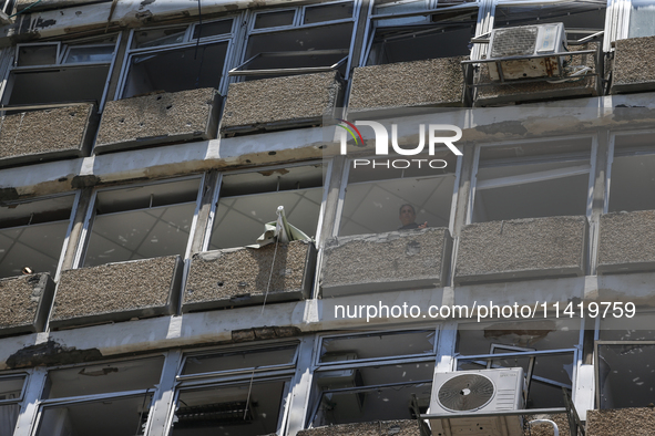 A view of a damaged building in the area of an explosion as Israeli policemen are searching the scene in Tel Aviv, Israel, on July 19, 2024....