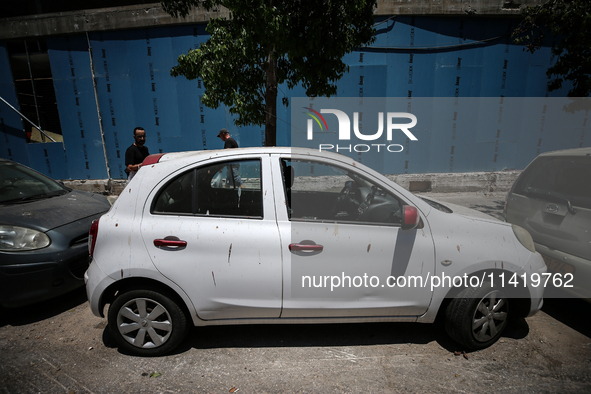 A view of a damaged building in the area of an explosion as Israeli policemen are searching the scene in Tel Aviv, Israel, on July 19, 2024....