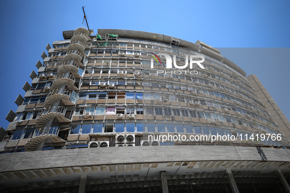 A view of a damaged building in the area of an explosion as Israeli policemen are searching the scene in Tel Aviv, Israel, on July 19, 2024....