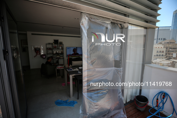 A view of a damaged building in the area of an explosion as Israeli policemen are searching the scene in Tel Aviv, Israel, on July 19, 2024....