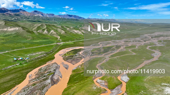 Reddish-brown water is meandering through a channel on the Tibetan Plateau in the upper reaches of Heihe River, China's second largest inlan...