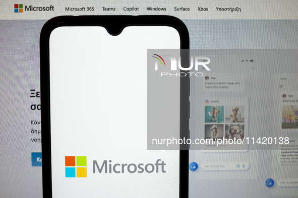 The Microsoft logo is being displayed on a smartphone screen with the Microsoft website in the background in Athens, Greece, on July 19, 202...