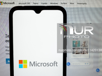 The Microsoft logo is being displayed on a smartphone screen with the Microsoft website in the background in Athens, Greece, on July 19, 202...