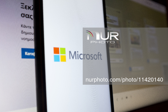 The Microsoft logo is being displayed on a smartphone screen with the Microsoft website in the background in Athens, Greece, on July 19, 202...