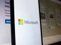 The Microsoft logo is being displayed on a smartphone screen with the Microsoft website in the background in Athens, Greece, on July 19, 202...