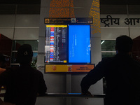 People are looking at the screen displaying an error message amid a global Microsoft outage at the Indira Gandhi International (IGI) Airport...