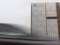 Vehicles are moving past an office building of Microsoft in Gurugram, on the outskirts of New Delhi, India, on July 19, 2024. Airlines, busi...