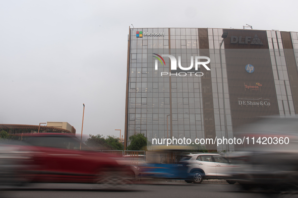 Vehicles are moving past an office building of Microsoft in Gurugram, on the outskirts of New Delhi, India, on July 19, 2024. Airlines, busi...