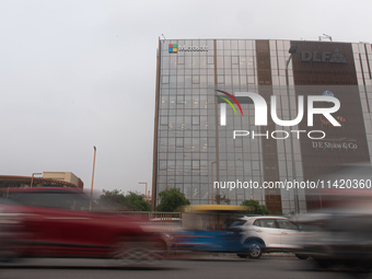 Vehicles are moving past an office building of Microsoft in Gurugram, on the outskirts of New Delhi, India, on July 19, 2024. Airlines, busi...