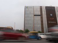 Vehicles are moving past an office building of Microsoft in Gurugram, on the outskirts of New Delhi, India, on July 19, 2024. Airlines, busi...